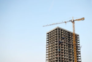 Tower cranes constructing a new residential building at a construction site in nyc